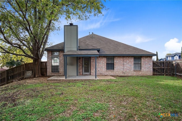 back of property with a yard and a patio