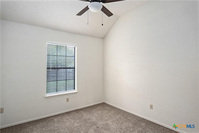 carpeted spare room featuring a textured ceiling, vaulted ceiling, and ceiling fan