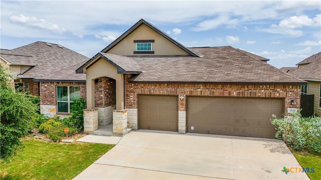 3542 Hurricane Trl, New Braunfels, TX 78130 - view of front of home with a garage, a shingled roof, driveway, and brick siding