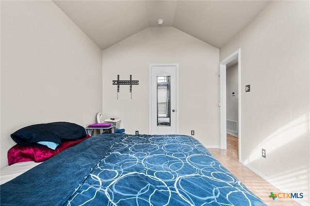 bedroom featuring lofted ceiling