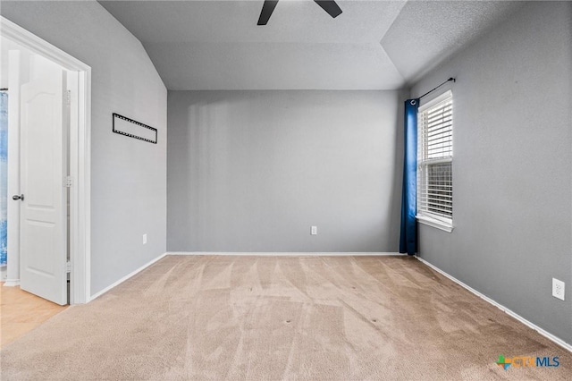 carpeted spare room featuring ceiling fan and a textured ceiling