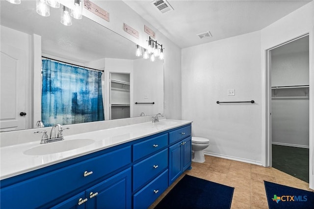 bathroom featuring vanity, toilet, and tile patterned floors