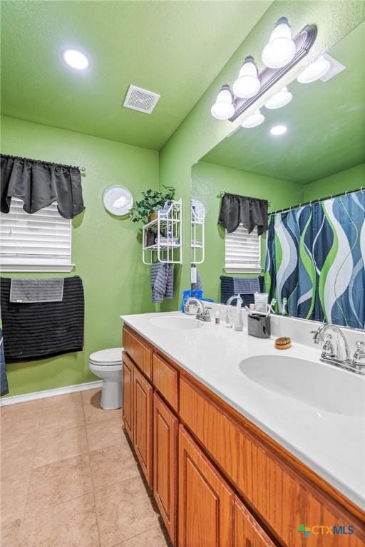 bathroom featuring vanity, toilet, and tile patterned floors