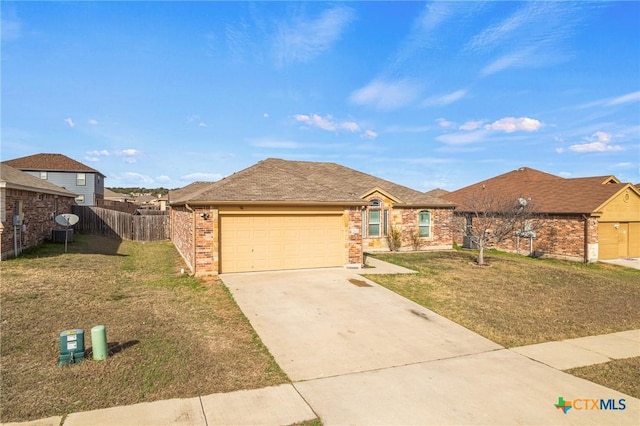 ranch-style house featuring a garage and a front lawn