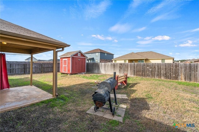 view of yard with a storage unit and a patio area