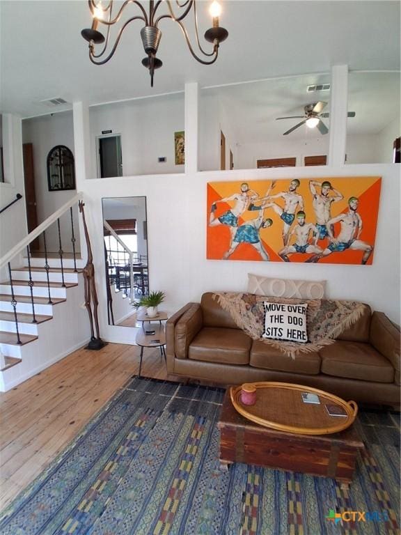 1837 Colleen Dr, Canyon Lake, TX 78133 - living area featuring wood finished floors, a ceiling fan, a chandelier, stairs, and baseboards