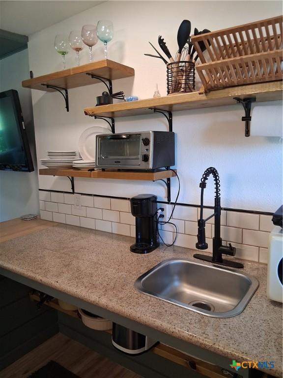 1837 Colleen Dr, Canyon Lake, TX 78133 - kitchen view of a sink, open shelves, and backsplash