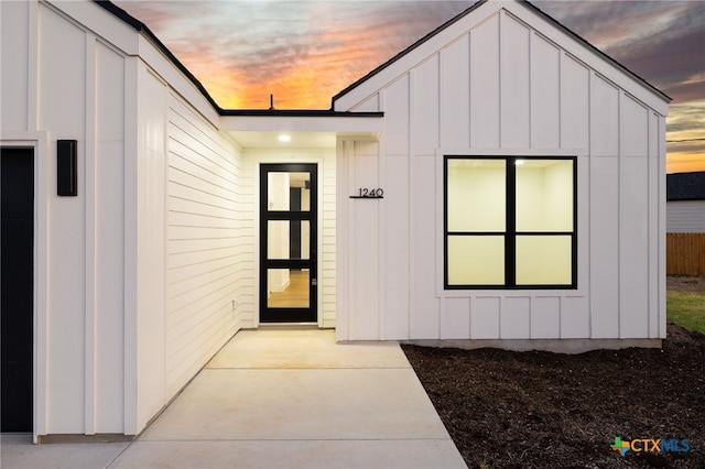 view of exterior entry at dusk