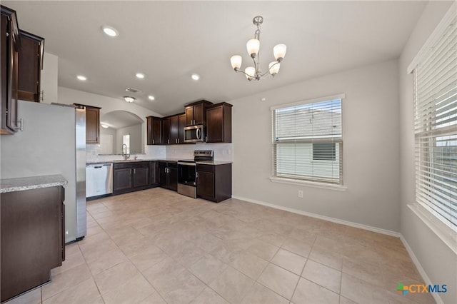 2048 Wigeon Way, Copperas Cove, TX 76522 - kitchen with appliances with stainless steel finishes, plenty of natural light, a chandelier, dark brown cabinets, and recessed lighting