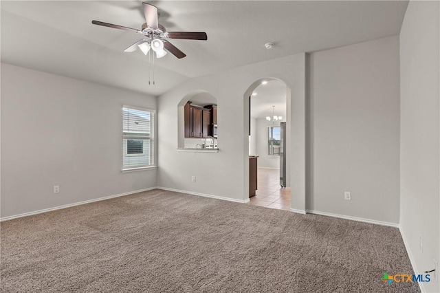2048 Wigeon Way, Copperas Cove, TX 76522 - spare room featuring light carpet, a ceiling fan, healthy amount of natural light, and arched walkways