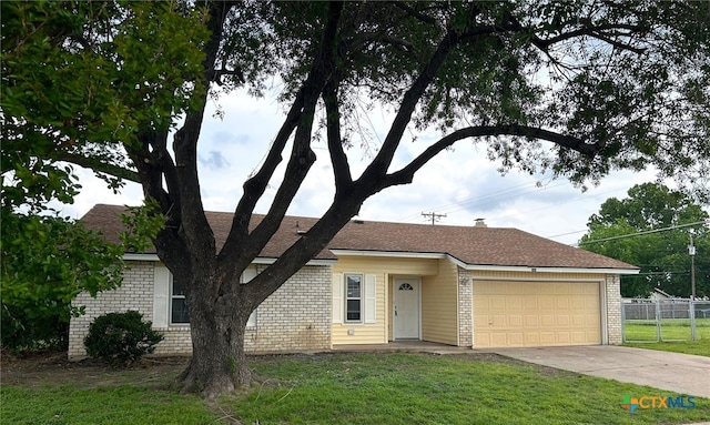view of front of home featuring a garage, fence, driveway, and brick siding