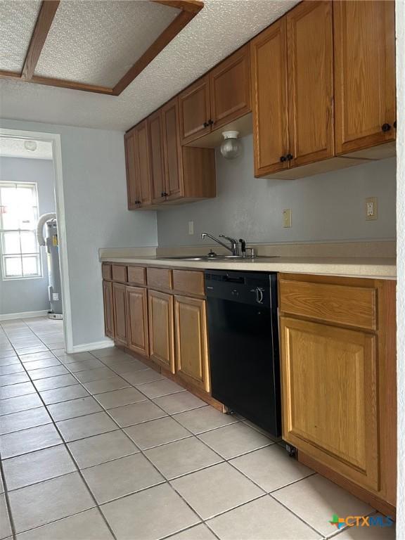 kitchen featuring a sink, light countertops, brown cabinetry, black dishwasher, and light tile patterned floors
