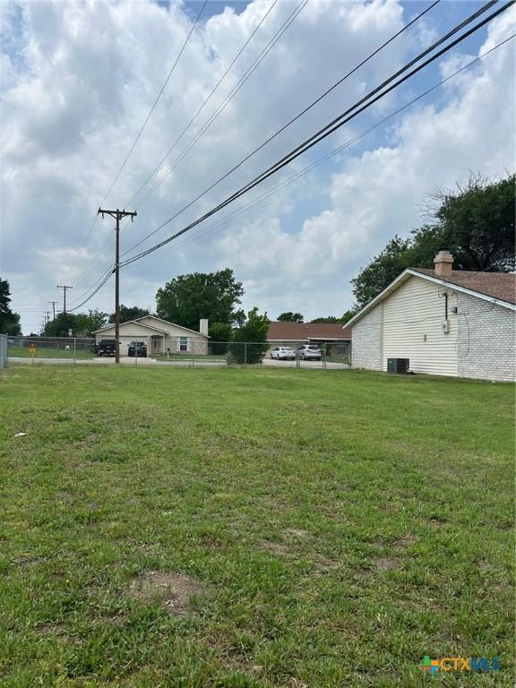 view of yard featuring fence and cooling unit