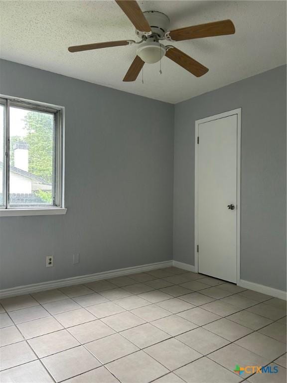 empty room featuring baseboards and ceiling fan