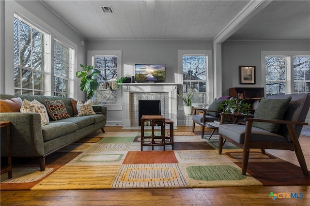 interior space with plenty of natural light, visible vents, and a fireplace with flush hearth