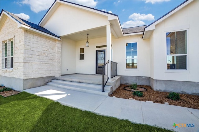 view of exterior entry with covered porch