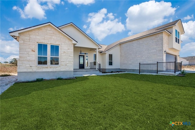 back of property featuring a lawn and a garage