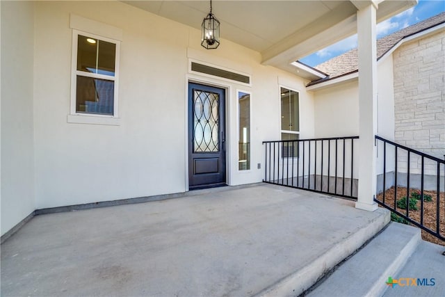 view of exterior entry with covered porch