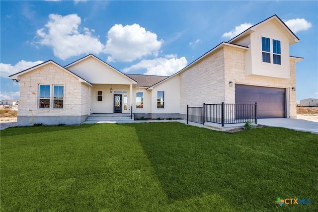 view of front of house with a porch, a garage, and a front lawn