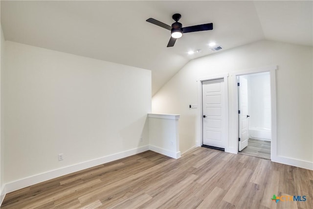 additional living space featuring ceiling fan, light hardwood / wood-style floors, and vaulted ceiling