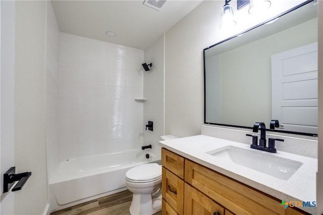 full bathroom featuring bathing tub / shower combination, hardwood / wood-style floors, vanity, and toilet