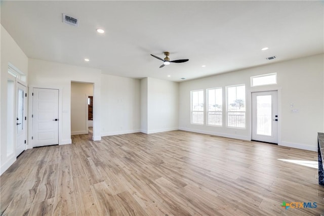 unfurnished living room featuring ceiling fan and light hardwood / wood-style flooring