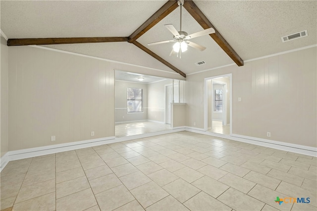 tiled spare room featuring ceiling fan, vaulted ceiling with beams, crown molding, and a textured ceiling