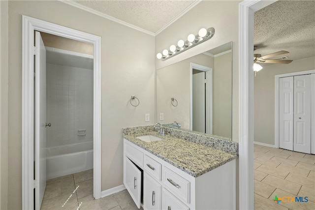 bathroom featuring a textured ceiling, tile patterned flooring, vanity, ceiling fan, and crown molding