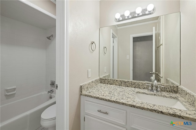 full bathroom with toilet, tiled shower / bath, and vanity