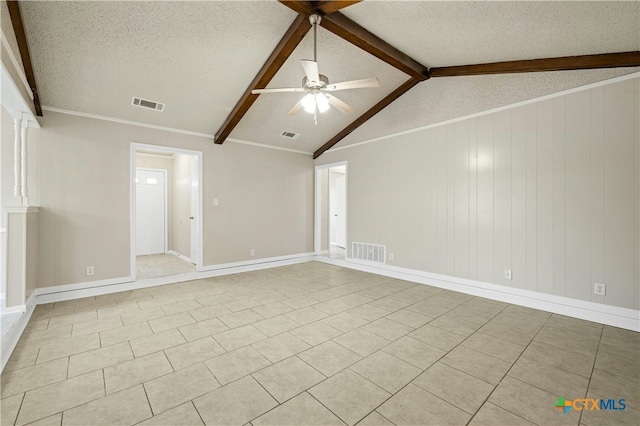 empty room with ceiling fan, lofted ceiling with beams, light tile patterned flooring, crown molding, and a textured ceiling