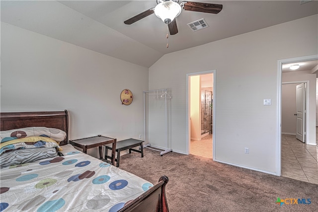 bedroom with ceiling fan, connected bathroom, light carpet, and lofted ceiling