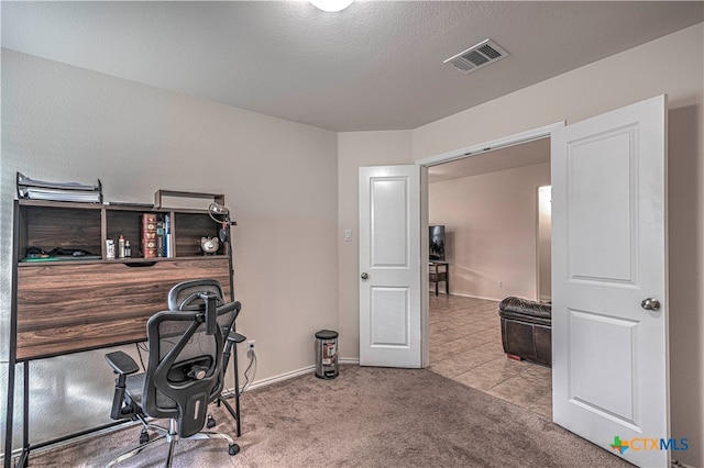 office featuring a textured ceiling and light colored carpet