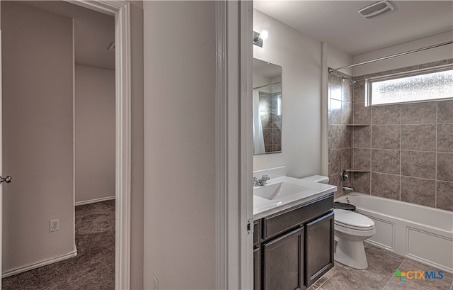 full bathroom with tiled shower / bath, vanity, toilet, and tile patterned floors