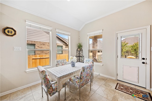 tiled dining space featuring vaulted ceiling