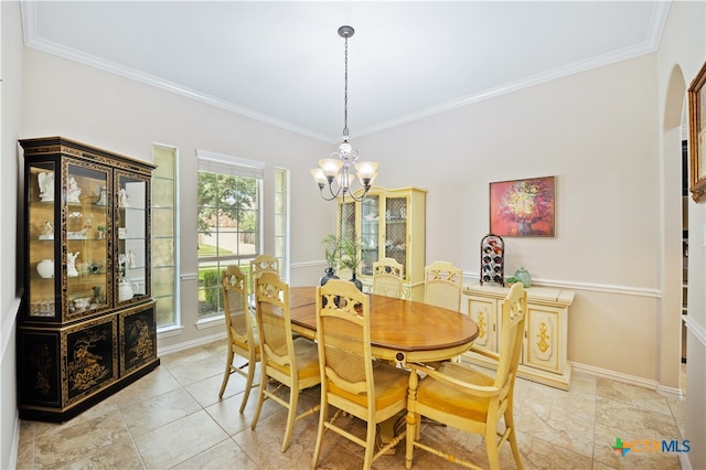 dining space with light tile patterned floors, crown molding, and a chandelier