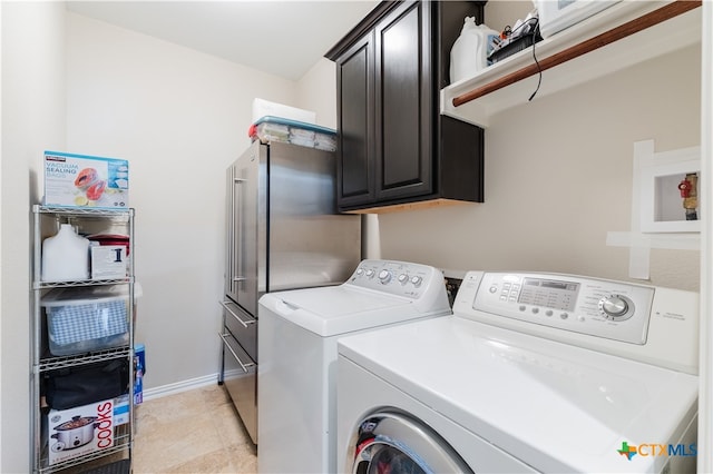 washroom featuring cabinets and washing machine and clothes dryer