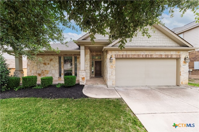 view of front of house featuring a garage and a front lawn