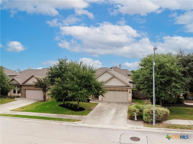 view of front of home with a front lawn and a garage