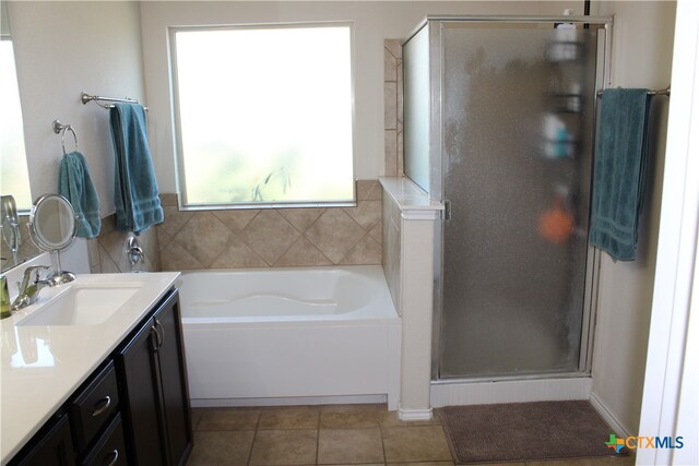 bathroom with independent shower and bath, tile patterned flooring, and vanity