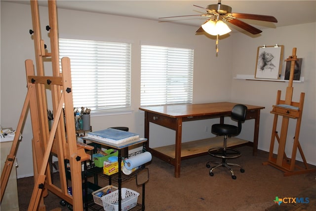 carpeted office space with ceiling fan