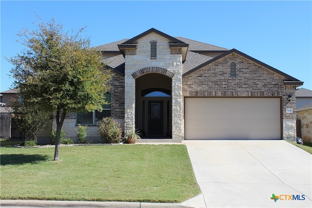 view of front of home with a garage and a front yard