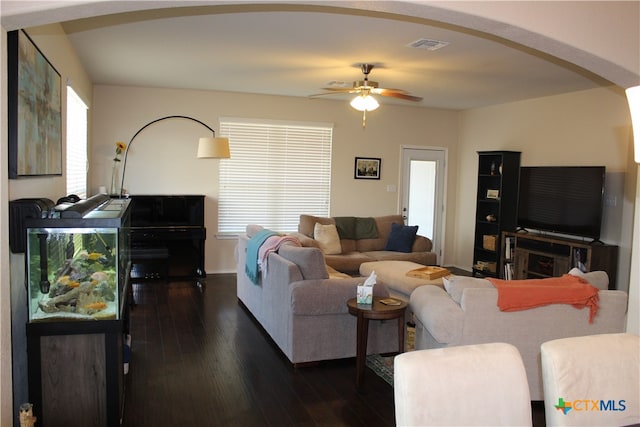 living room with ceiling fan and dark hardwood / wood-style flooring