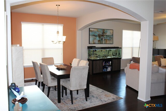 dining space with dark hardwood / wood-style floors and plenty of natural light