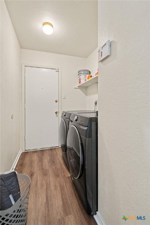 1801 Caprock Dr, Killeen, TX 76549 - washroom featuring washing machine and dryer and wood finished floors