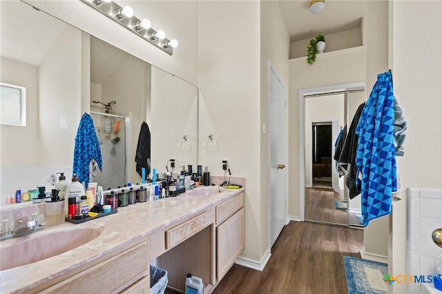 1801 Caprock Dr, Killeen, TX 76549 - full bath featuring double vanity, wood finished floors, and a shower stall