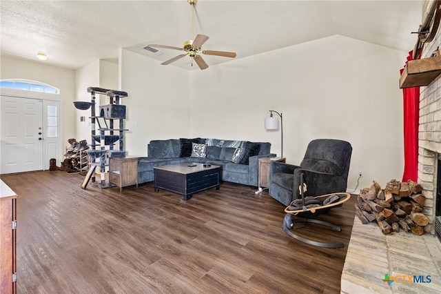 1801 Caprock Dr, Killeen, TX 76549 - living room featuring a brick fireplace, wood finished floors, ceiling fan, and vaulted ceiling
