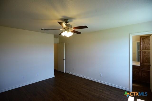 unfurnished room with dark hardwood / wood-style floors and ceiling fan