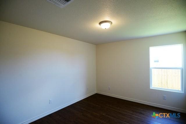 empty room featuring dark wood-type flooring