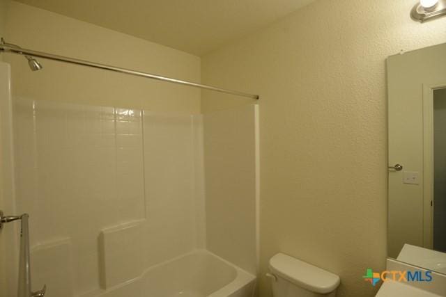 bathroom featuring toilet and tub / shower combination