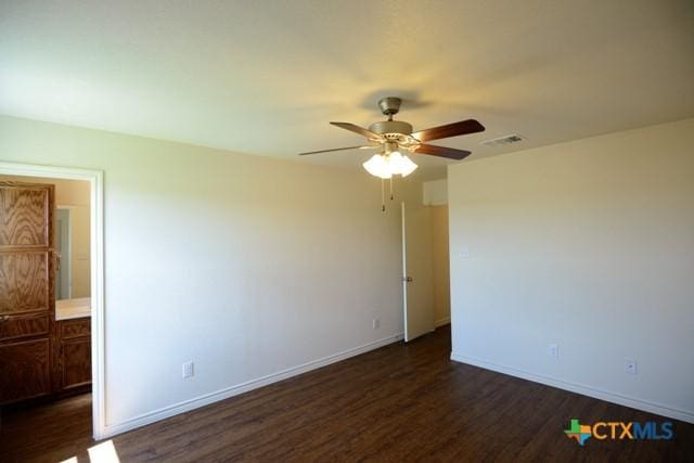 unfurnished room featuring dark hardwood / wood-style floors and ceiling fan